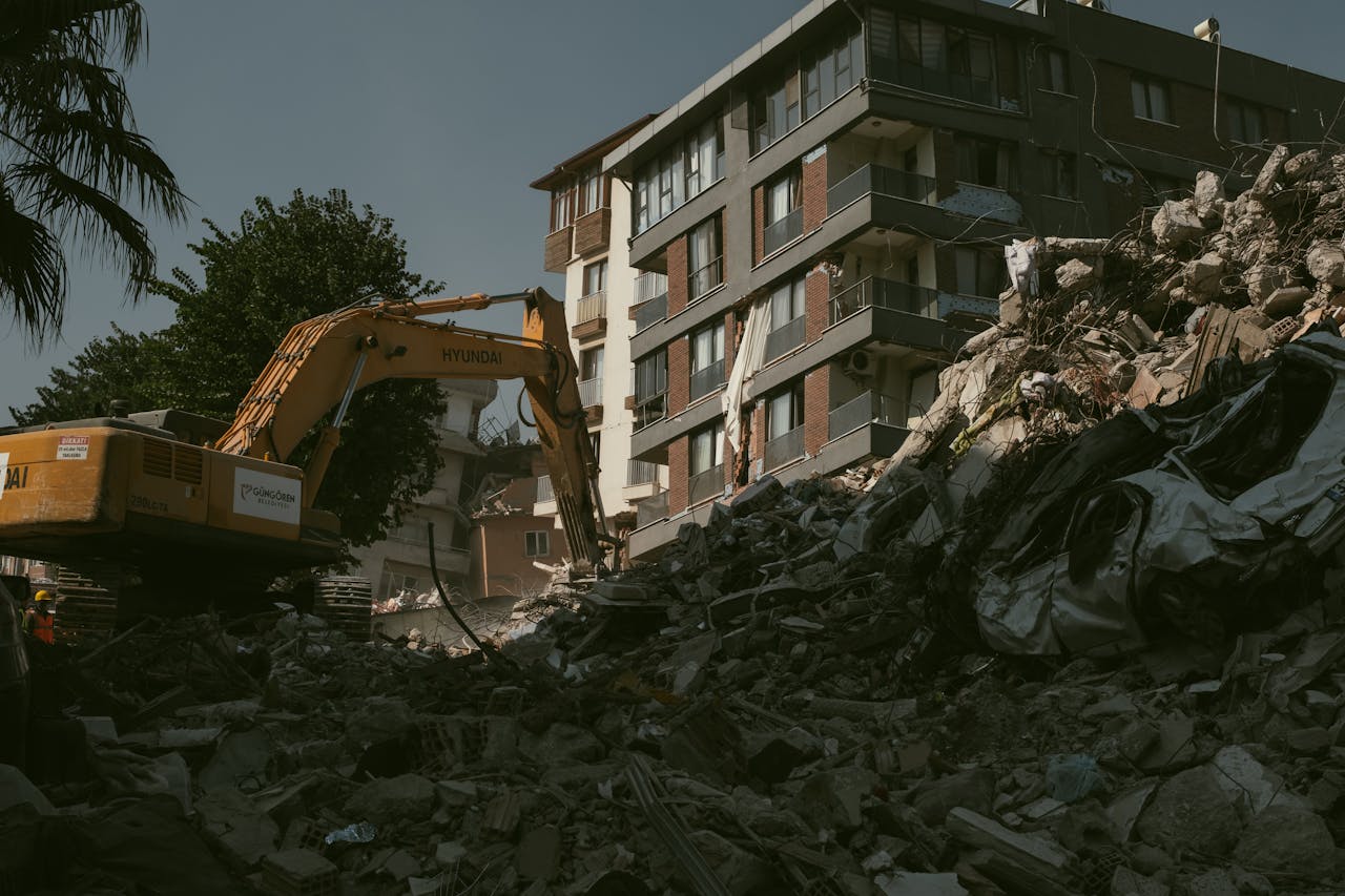 home-hero Excavator removing rubble from a collapsed building area in Antakya, Türkiye.